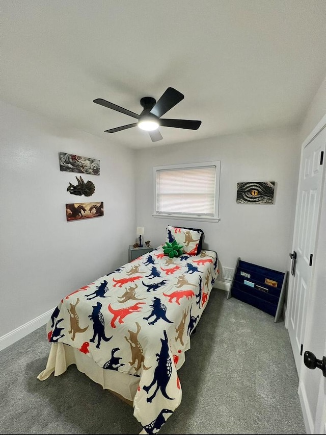 carpeted bedroom featuring a closet, baseboards, and a ceiling fan