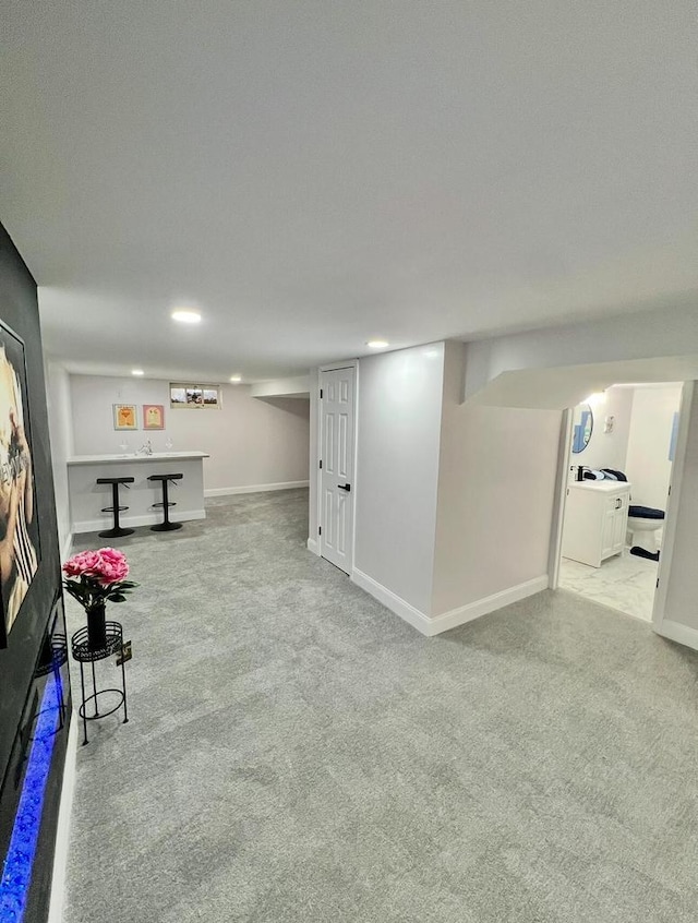 interior space with recessed lighting, baseboards, washer / dryer, and carpet flooring