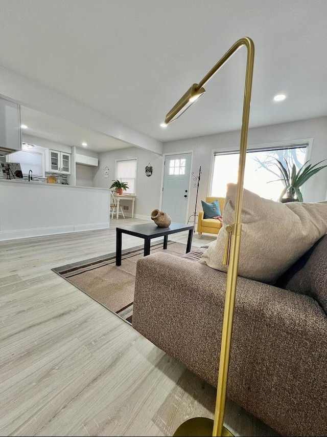 living area with recessed lighting and wood finished floors