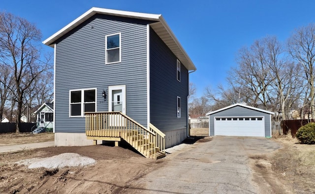 exterior space with a garage and an outbuilding