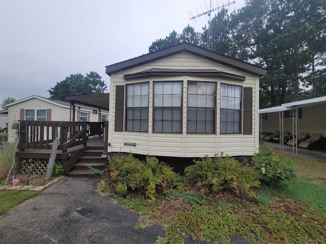 view of property exterior featuring a wooden deck