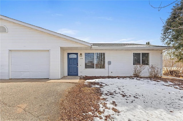 single story home with a garage and a shingled roof