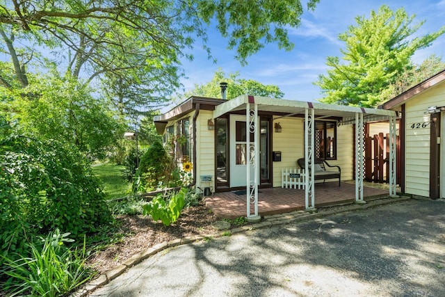 exterior space featuring a porch and fence