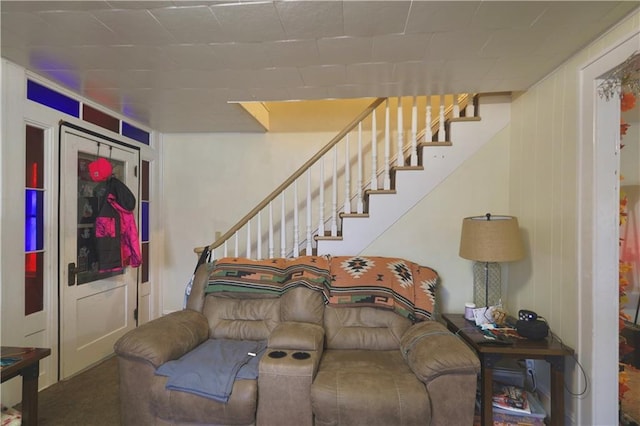 carpeted living room featuring stairway