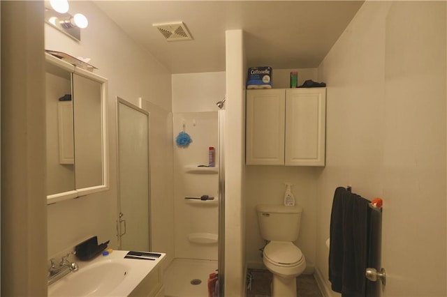 bathroom featuring visible vents, vanity, toilet, and a shower stall