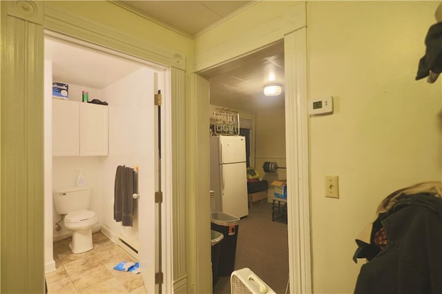 bathroom with toilet and baseboard heating