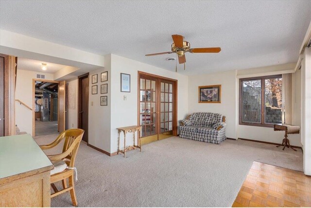 interior space featuring baseboards, carpet flooring, french doors, a textured ceiling, and a ceiling fan