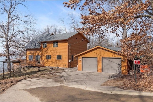 view of front of house featuring concrete driveway and an attached garage