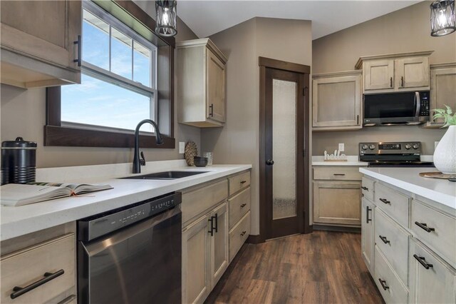 3557 114th St, Chippewa Falls, WI 54729 - kitchen with stainless steel appliances, a sink, dark wood-style flooring, light countertops, and hanging light fixtures