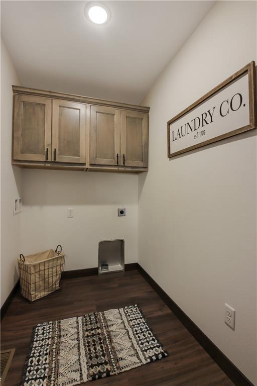 3557 114th St, Chippewa Falls, WI 54729 - clothes washing area with electric dryer hookup, cabinet space, visible vents, and baseboards