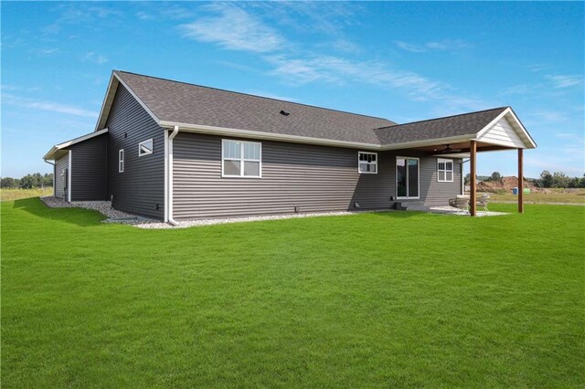 3557 114th St, Chippewa Falls, WI 54729 - back of property with a lawn, a shingled roof, and a patio