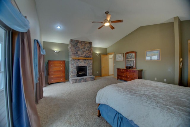 bedroom featuring a stone fireplace, lofted ceiling, carpet, and ceiling fan