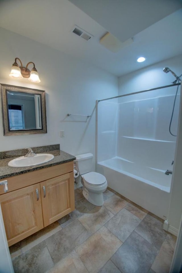 bathroom featuring tub / shower combination, visible vents, toilet, and vanity