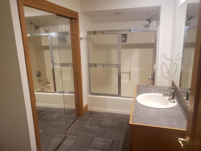 bathroom featuring enclosed tub / shower combo and vanity