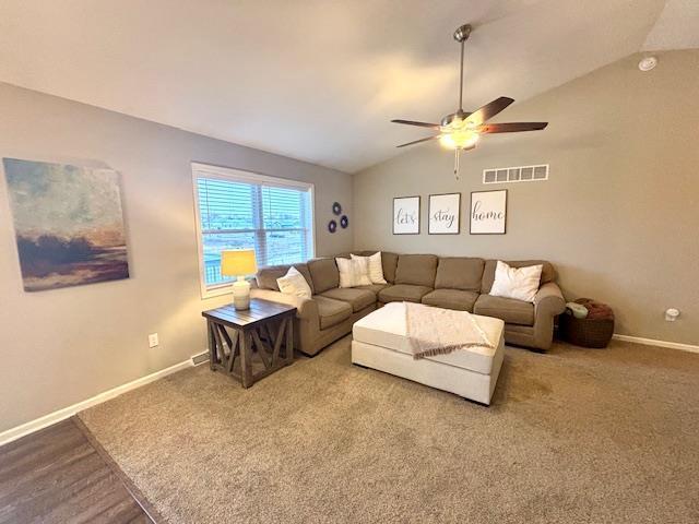 living room with vaulted ceiling, baseboards, visible vents, and ceiling fan