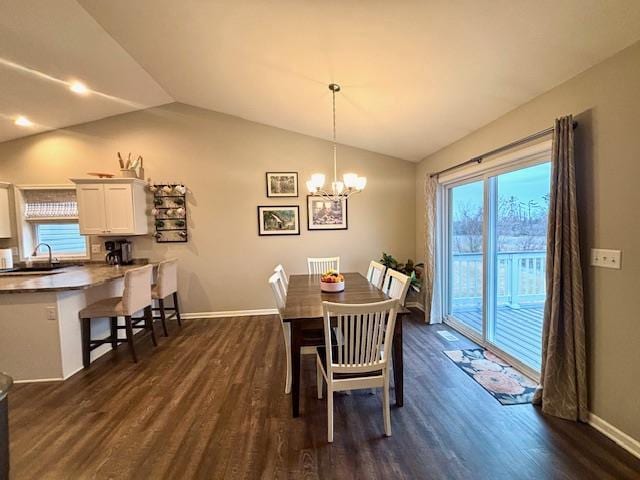 dining room with lofted ceiling, a notable chandelier, baseboards, and dark wood-style flooring