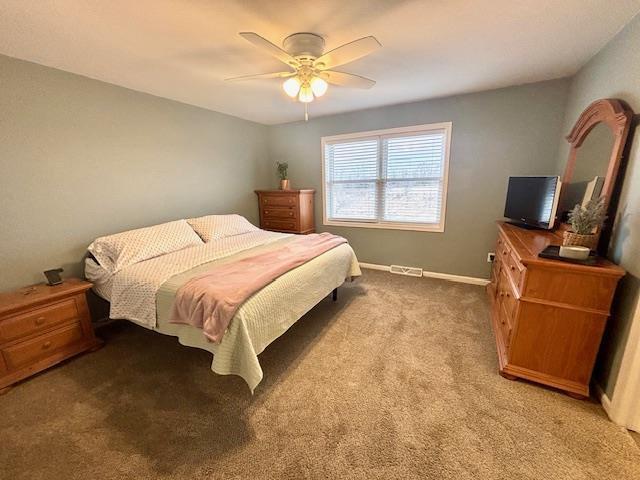 bedroom with visible vents, ceiling fan, baseboards, and carpet floors