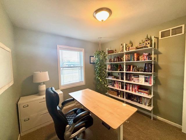 home office with visible vents, baseboards, and carpet floors