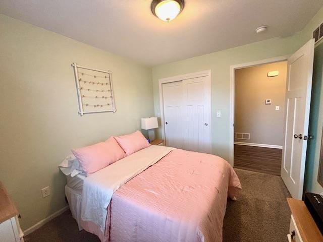 carpeted bedroom featuring visible vents, baseboards, and a closet