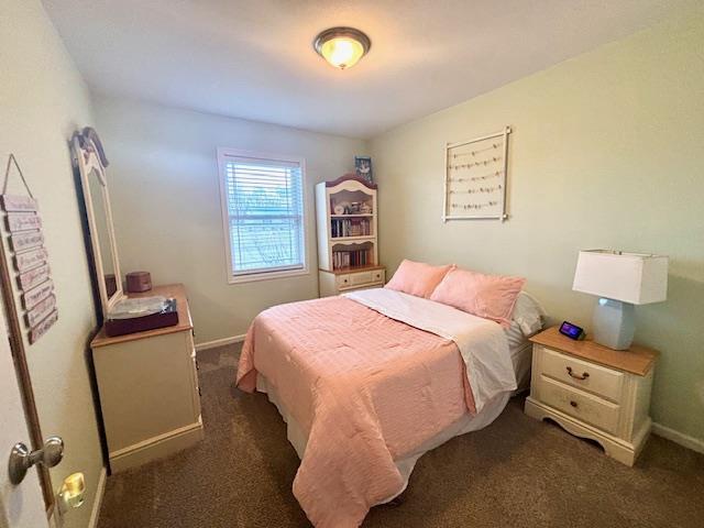 carpeted bedroom featuring baseboards