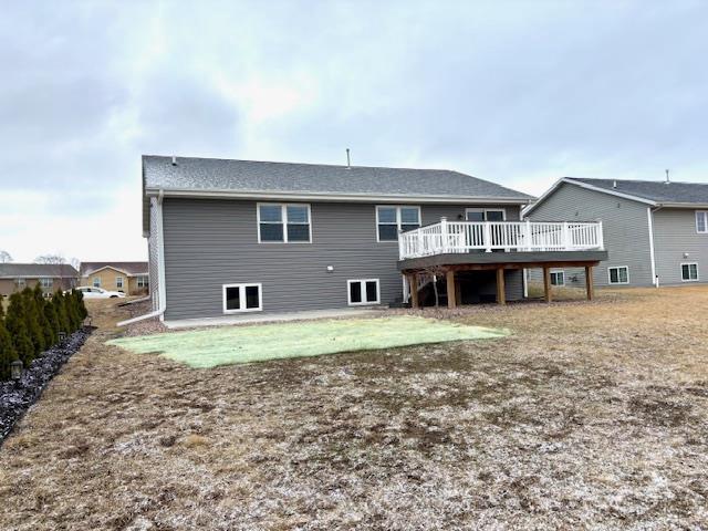 rear view of property featuring a deck