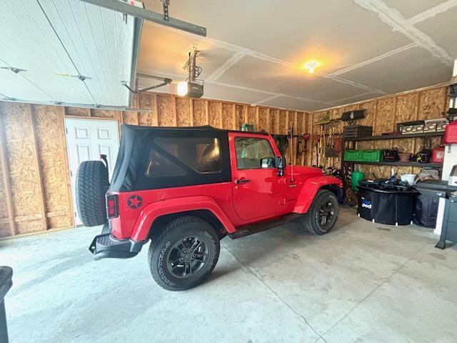 garage featuring wooden walls and a garage door opener