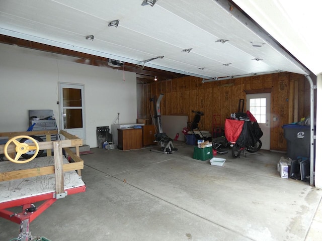 garage featuring wooden walls and a garage door opener