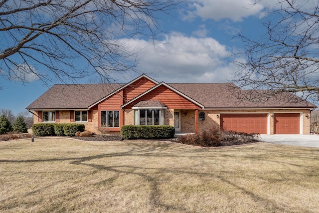 single story home featuring brick siding, an attached garage, concrete driveway, and a front lawn