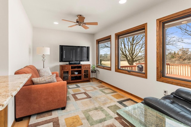 living room featuring recessed lighting, baseboards, and ceiling fan