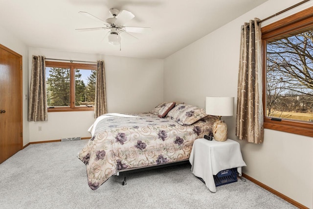 bedroom featuring visible vents, carpet flooring, baseboards, and ceiling fan