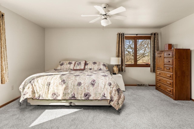 bedroom with ceiling fan, baseboards, and carpet