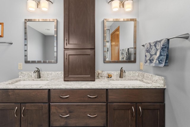 full bath featuring double vanity and a sink