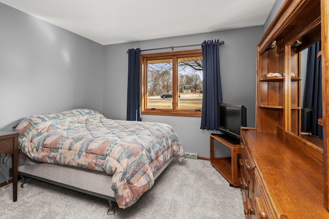 bedroom with baseboards and carpet