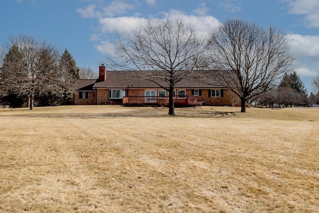 view of front of home featuring a front yard and a chimney