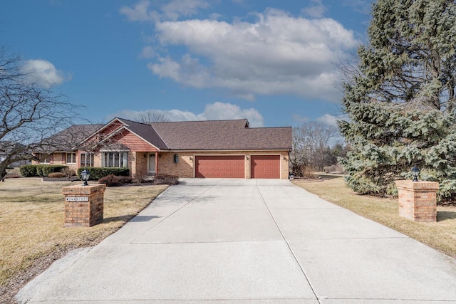 view of front of home with a front yard, a garage, and driveway