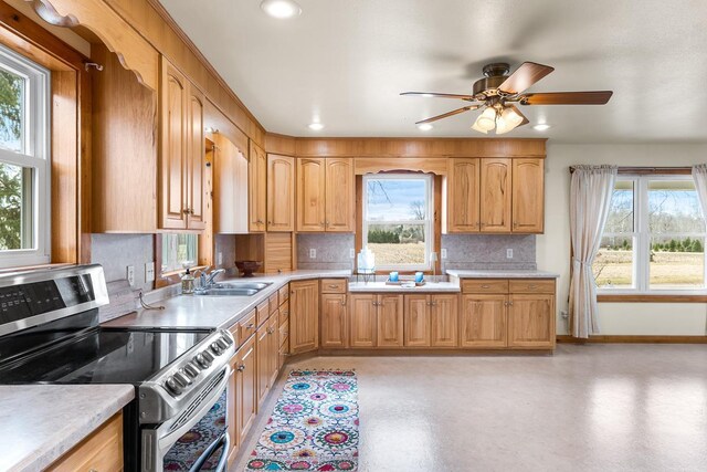 N402 24th Ave, Neshkoro, WI 54960 - kitchen with light countertops, a sink, a ceiling fan, tasteful backsplash, and stainless steel electric stove