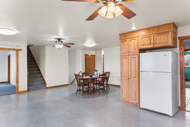 N402 24th Ave, Neshkoro, WI 54960 - dining space with concrete flooring, baseboards, stairs, and ceiling fan