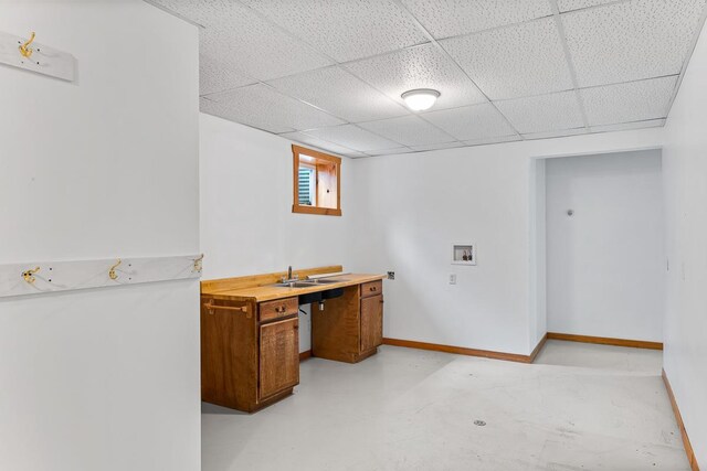 N402 24th Ave, Neshkoro, WI 54960 - interior space with baseboards, concrete floors, a sink, and a paneled ceiling
