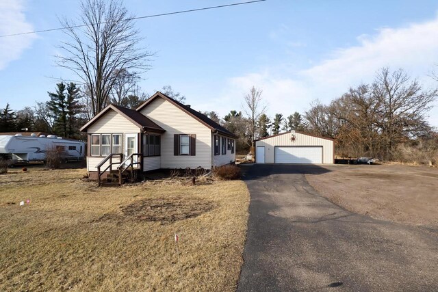 523 State Highway 73, Nekoosa, WI 54457 - view of front facade with a detached garage and an outbuilding