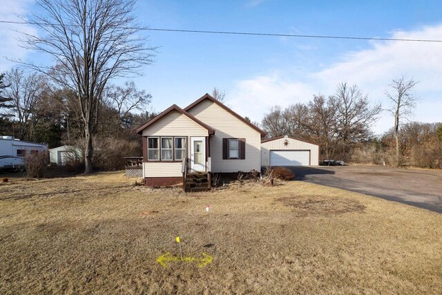 523 State Highway 73, Nekoosa, WI 54457 - view of front of house with entry steps, an outbuilding, and a garage
