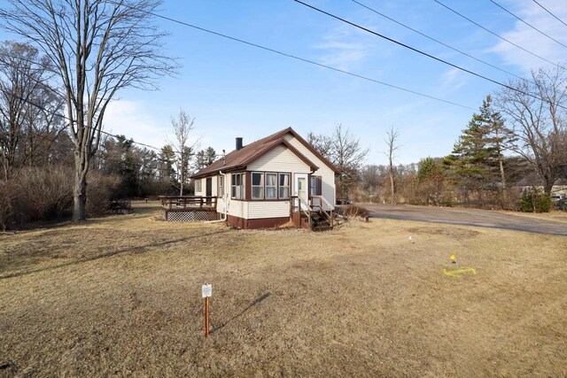 523 State Highway 73, Nekoosa, WI 54457 - view of front facade featuring a wooden deck and a front yard