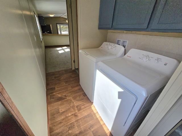 W5029 N Pathfinder Cir, Shawano, WI 54166 - laundry area featuring cabinet space, light wood-style floors, and washing machine and clothes dryer