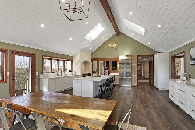 2842 Moelter Dr, Lake Geneva, WI 53147 - dining area with beamed ceiling, a notable chandelier, dark wood finished floors, recessed lighting, and a skylight