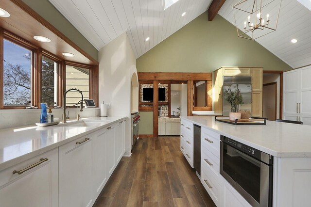 2842 Moelter Dr, Lake Geneva, WI 53147 - kitchen featuring dark wood-type flooring, a chandelier, beamed ceiling, high end fridge, and white cabinetry