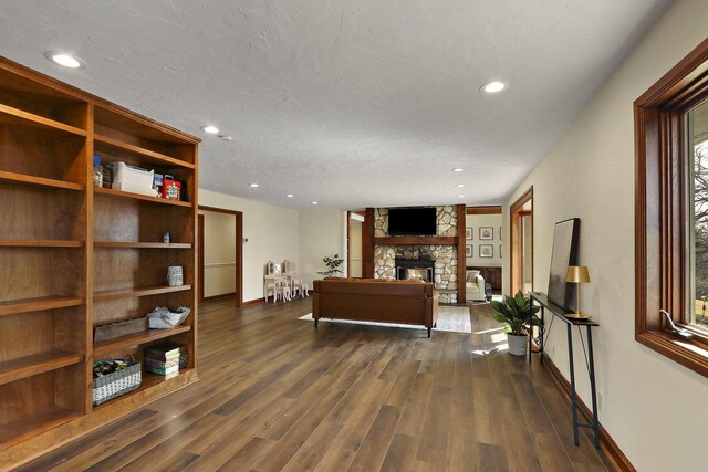 2842 Moelter Dr, Lake Geneva, WI 53147 - living area with a textured ceiling, dark wood-style floors, recessed lighting, a stone fireplace, and baseboards