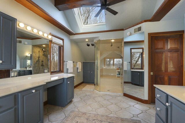 2842 Moelter Dr, Lake Geneva, WI 53147 - bathroom featuring visible vents, ceiling fan, a wealth of natural light, vaulted ceiling with skylight, and a stall shower