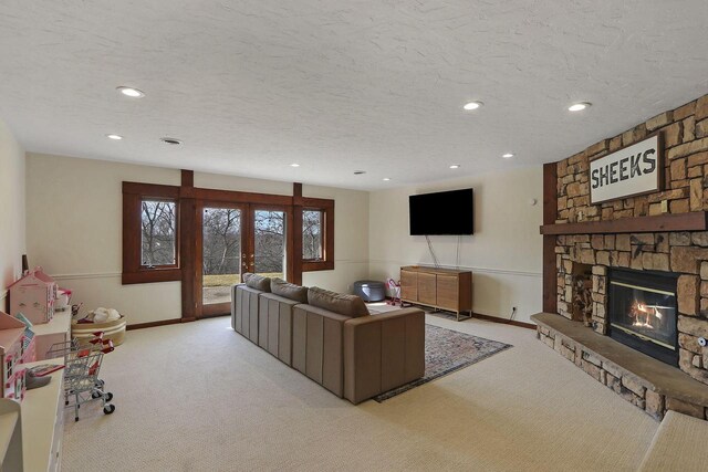 2842 Moelter Dr, Lake Geneva, WI 53147 - living area with french doors, a textured ceiling, a stone fireplace, and carpet