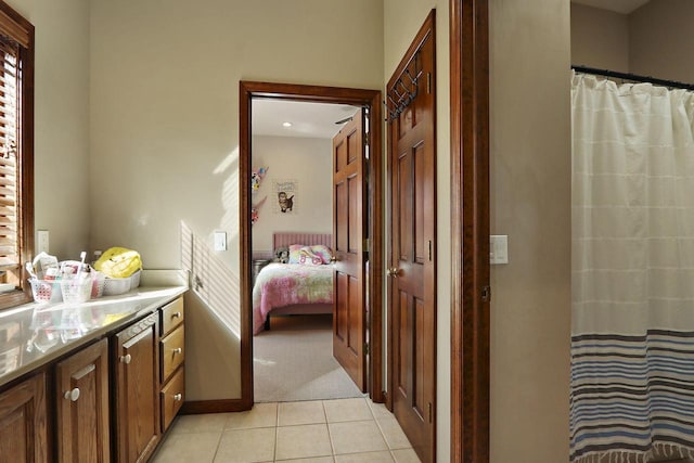 2842 Moelter Dr, Lake Geneva, WI 53147 - ensuite bathroom featuring tile patterned floors, ensuite bathroom, a shower with shower curtain, baseboards, and vanity