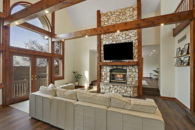2842 Moelter Dr, Lake Geneva, WI 53147 - living area with visible vents, high vaulted ceiling, a stone fireplace, and dark wood-style flooring