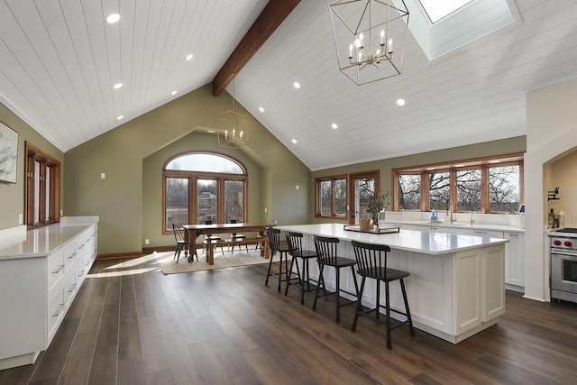 2842 Moelter Dr, Lake Geneva, WI 53147 - kitchen featuring dark wood finished floors, a large island, vaulted ceiling with beams, and white cabinetry